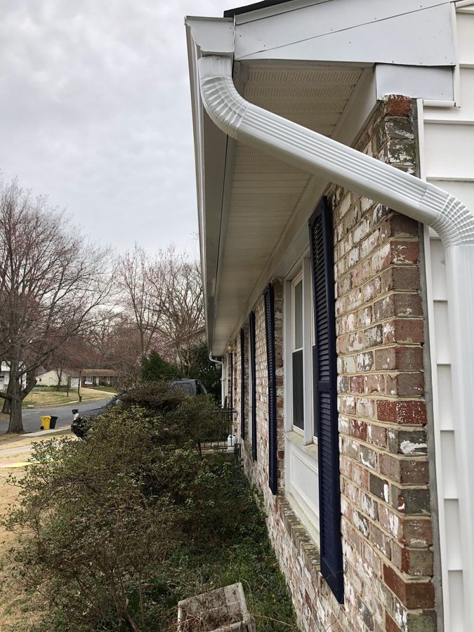 Looking up at a downspout, elbow and gutter return at a corner